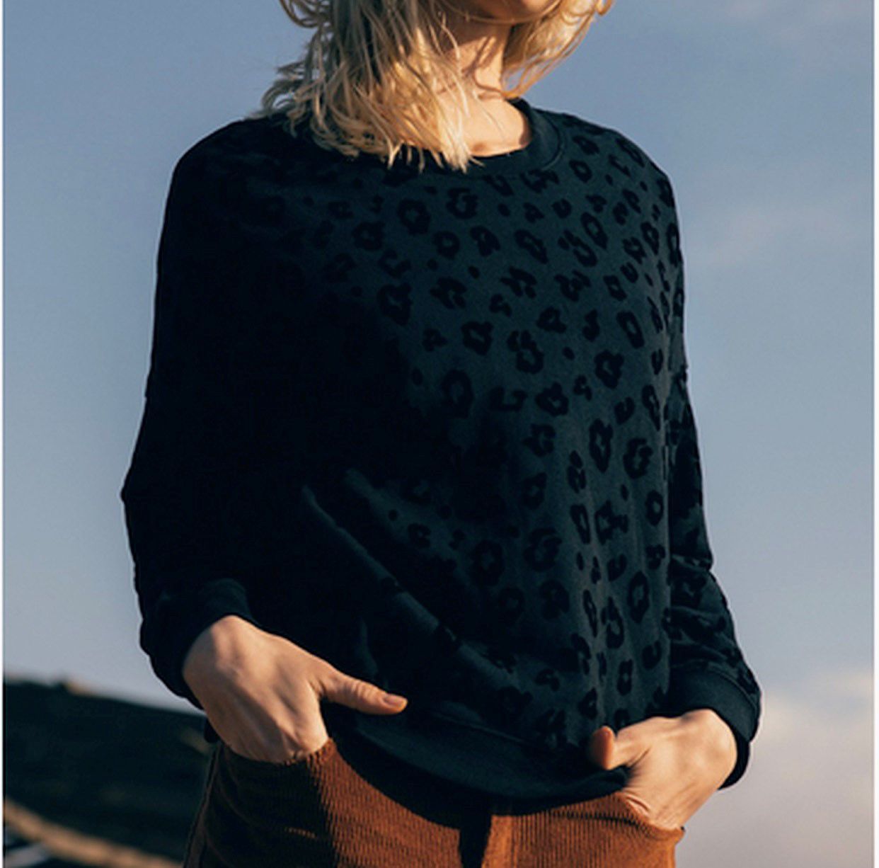 Tonal black flocked leopard print sweatshirt.